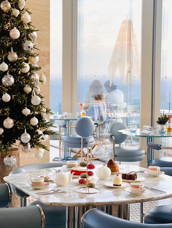 christmas tea time served on a marble table including tea coffee and cakes