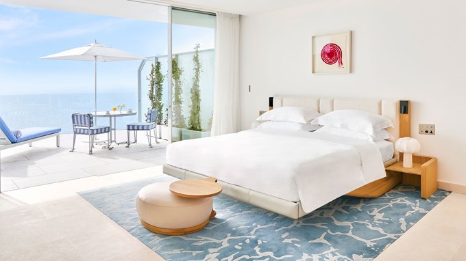 The Grand Sea View Studio is a modern white room featuring chic wooden themes and a uninterrupted view of the sea