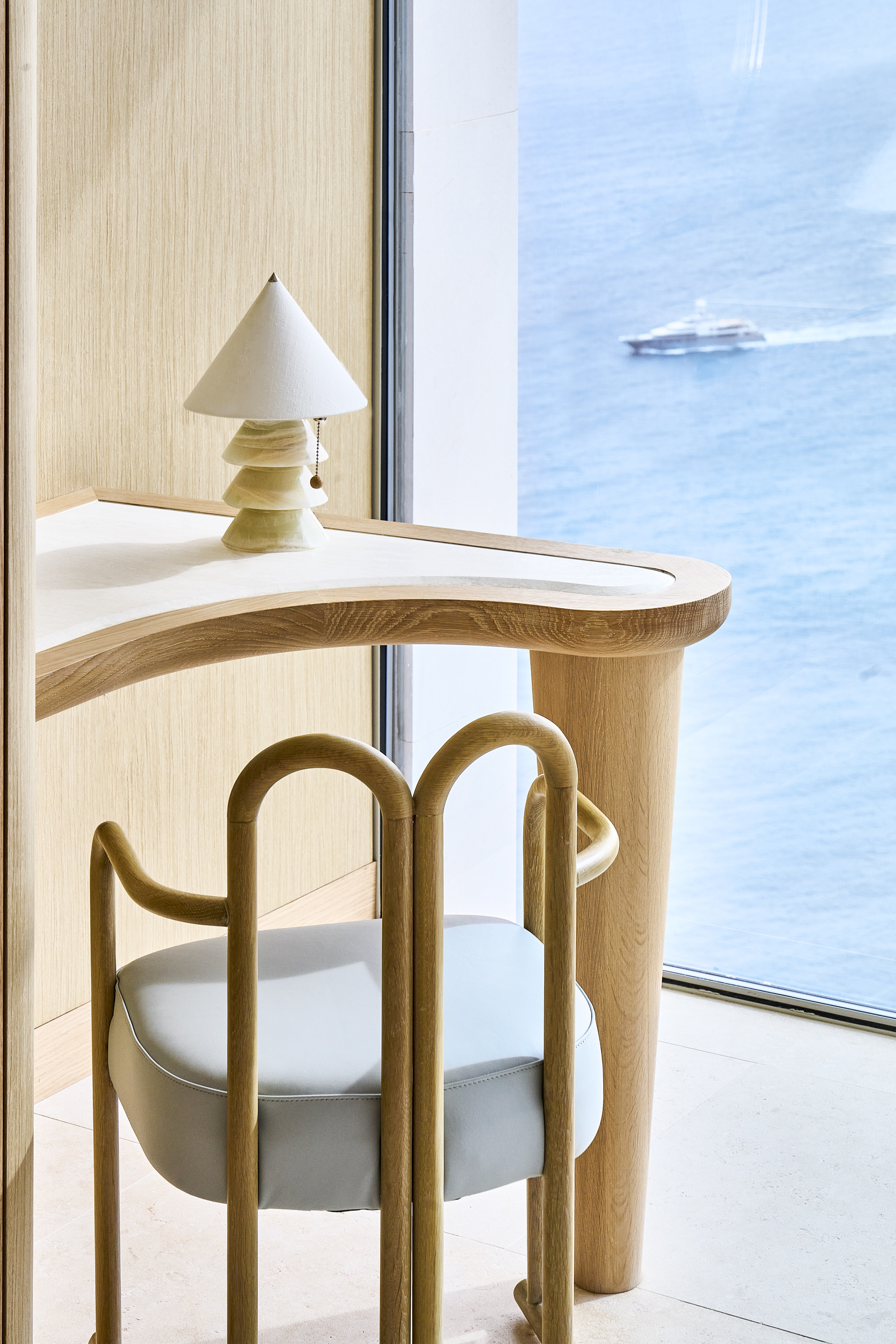 The Maybourne Riviera - desk with chair in front of it and view onto the sea through the window.