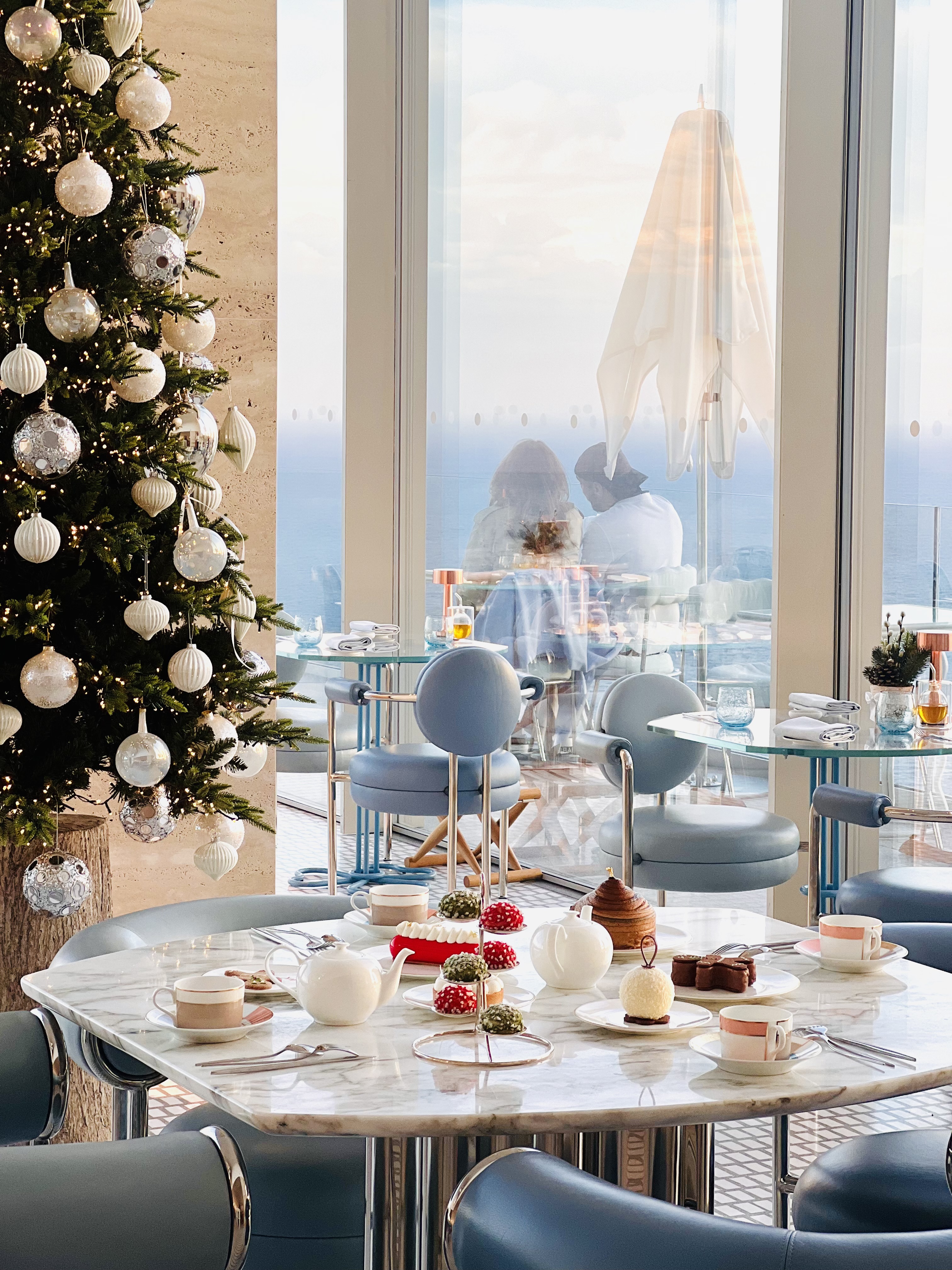 tea time on a marble table at christmas time with tea coffee cakes